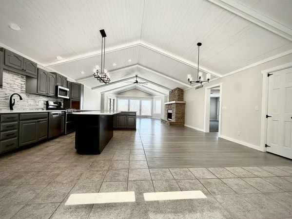 a view of a kitchen with a sink stainless steel appliances and cabinets