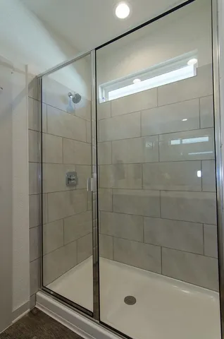 a bathroom with a shower and toilet