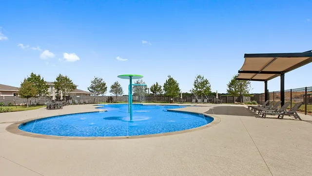 a view of a swimming pool with a lounge chair