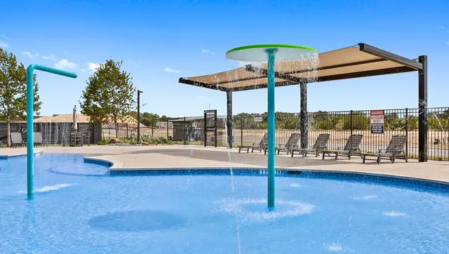a view of a swimming pool with a lounge chair