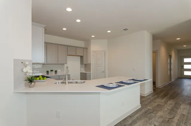 a kitchen with stainless steel appliances a sink stove and cabinets