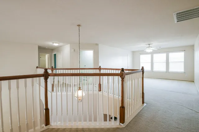 a view of a hallway with windows