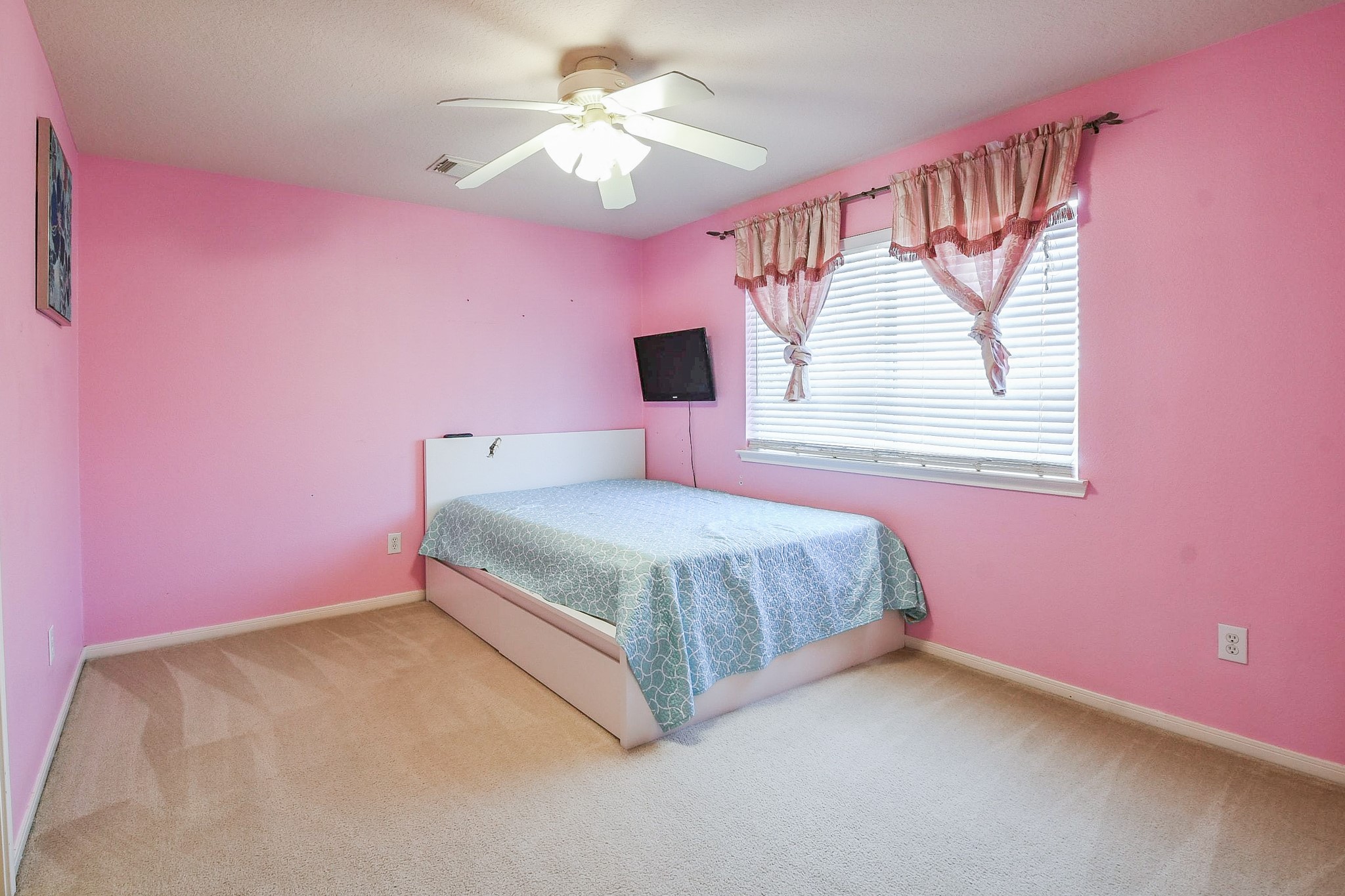 24219 Camillia Ridge Way Katy, TX 77493 - Photo 23 of 32 a bedroom with a bed and a chandelier fan