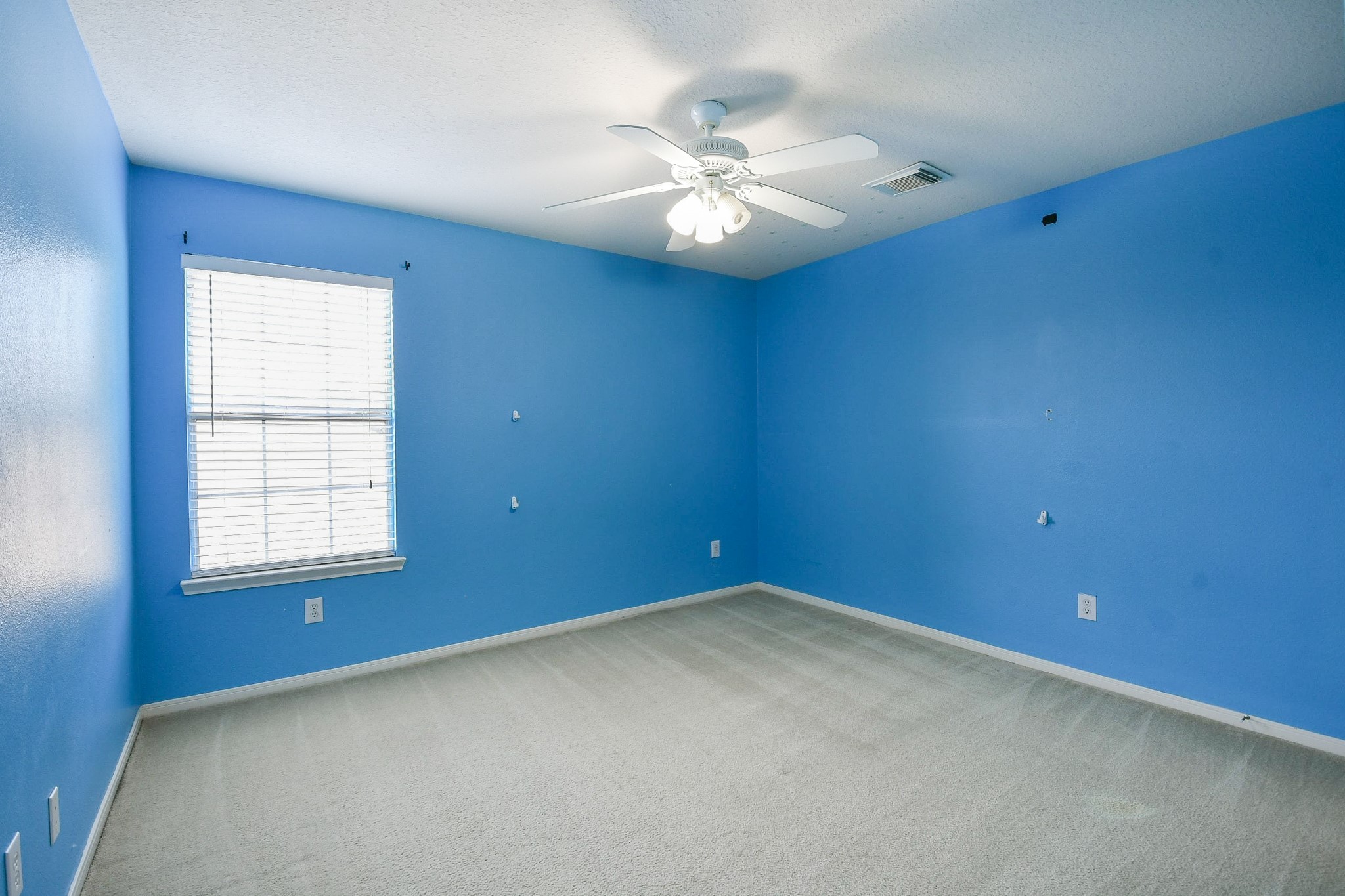 24219 Camillia Ridge Way Katy, TX 77493 - Photo 25 of 32 an empty room with windows and fan
