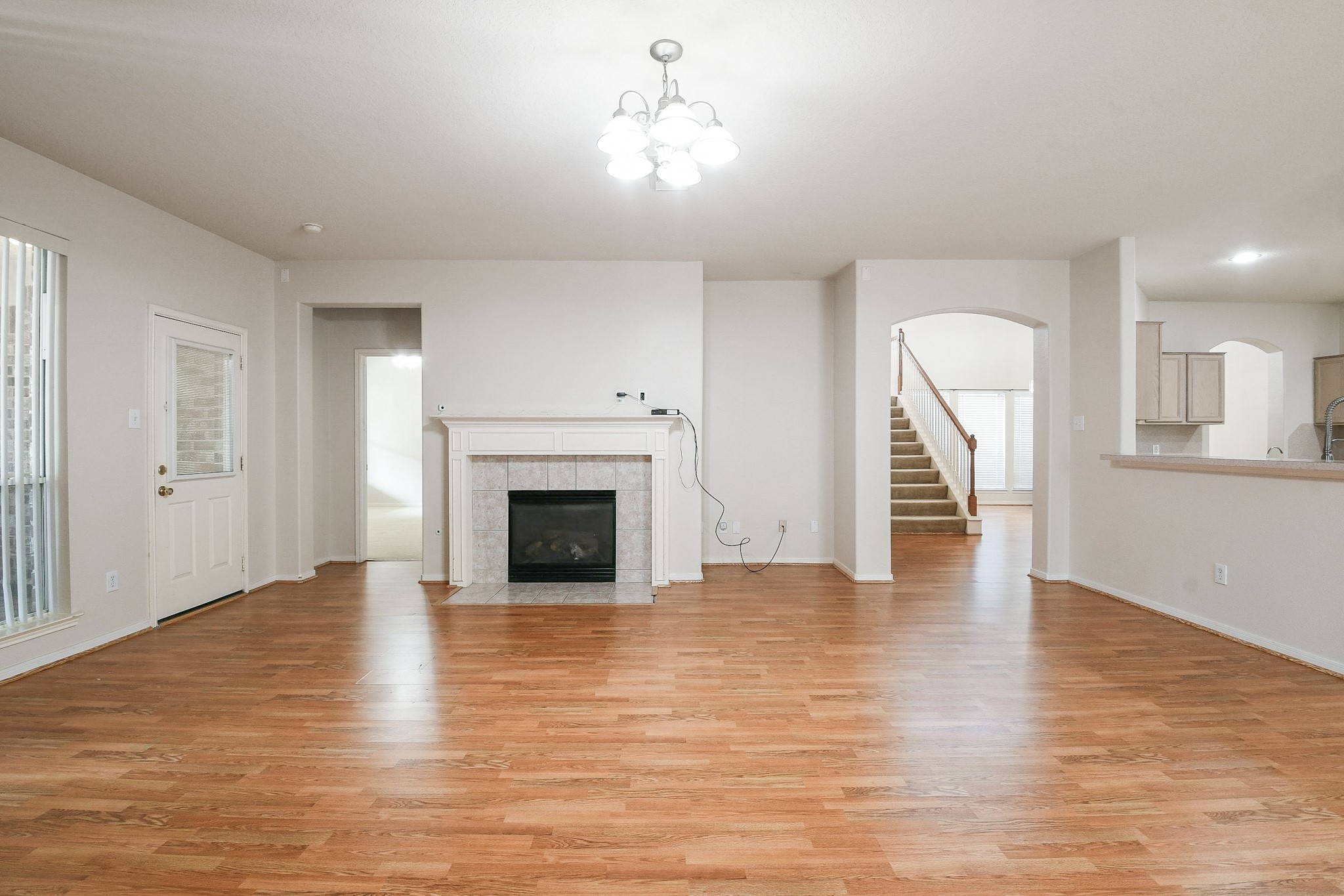 24219 Camillia Ridge Way Katy, TX 77493 - Photo 5 of 32 a view of empty room with wooden floor and fireplace