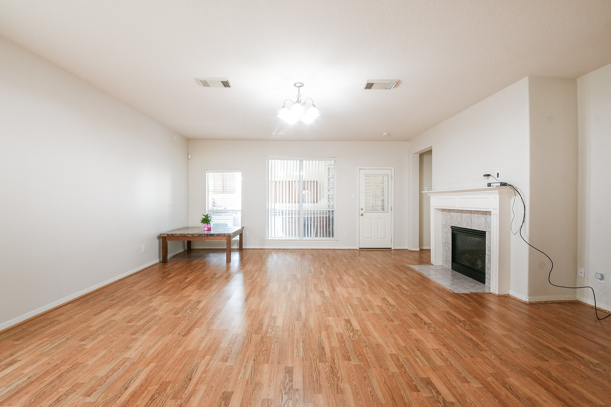 24219 Camillia Ridge Way Katy, TX 77493 - Photo 7 of 32 an empty room with wooden floor and fireplace