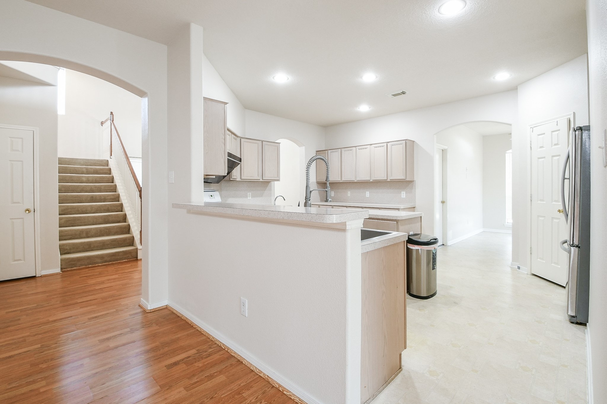 24219 Camillia Ridge Way Katy, TX 77493 - Photo 9 of 32 a kitchen with kitchen island a sink stainless steel appliances and cabinets