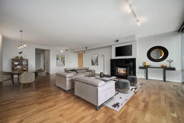 a living room with furniture a fireplace and a flat screen tv