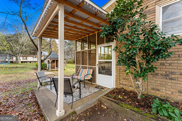 a view of a patio with table and chairs and potted plants