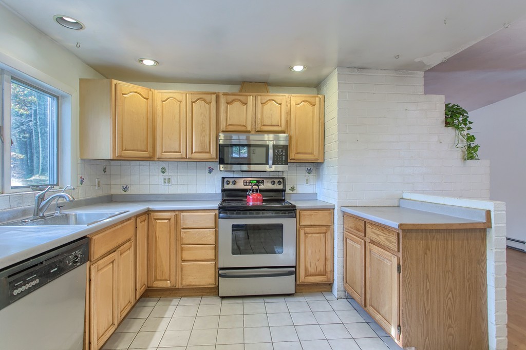 49 Clarissa Road Chelmsford, MA 01824 - Photo 7 of 25 a kitchen with a sink cabinets and appliances