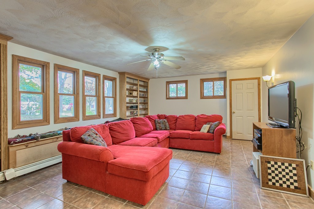 49 Clarissa Road Chelmsford, MA 01824 - Photo 9 of 25 a living room with furniture and a flat screen tv