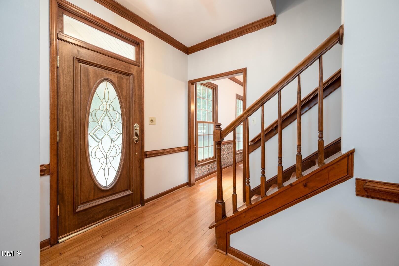 5020 Celbridge Place Raleigh, NC 27613 - Photo 9 of 52 a view of an entryway with wooden floor and door