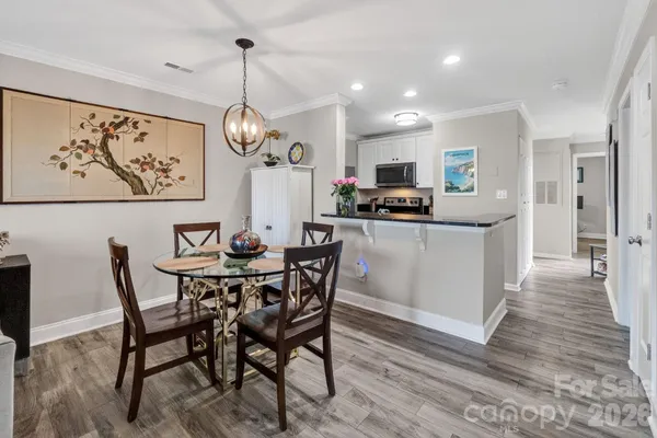 a view of a dining room with furniture wooden floor and a chandelier