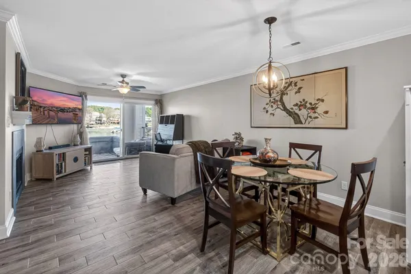 a view of a dining room with furniture a chandelier and wooden floor
