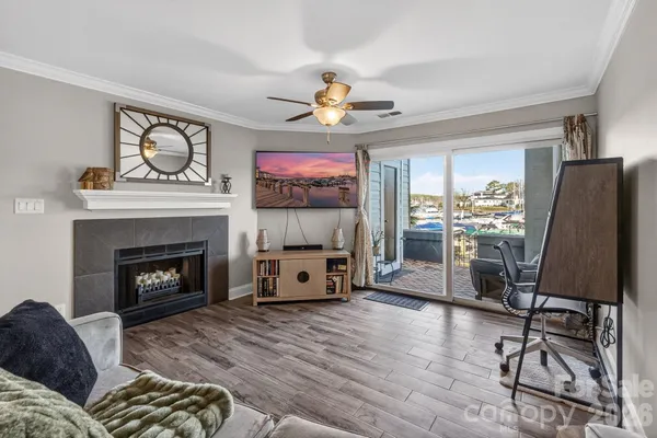 a living room with furniture a fireplace and a flat screen tv