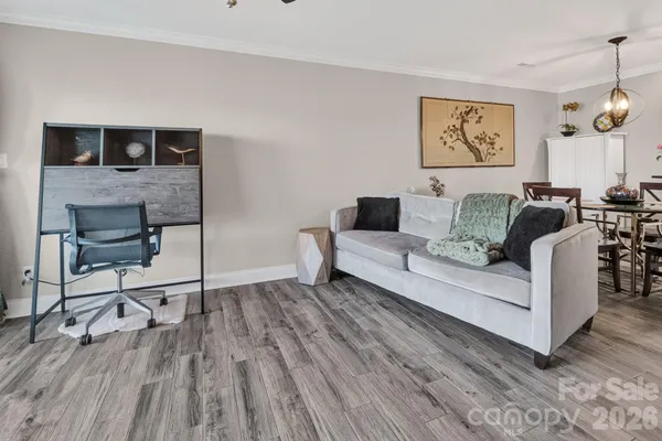 a living room with furniture and wooden floor