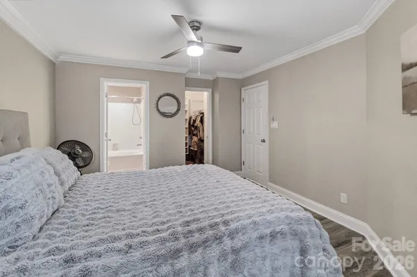 a bedroom with a bed and a ceiling fan