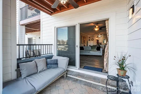 a balcony with furniture and a potted plant
