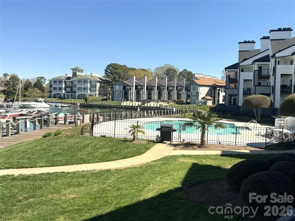 a view of a big building with a big yard and large trees
