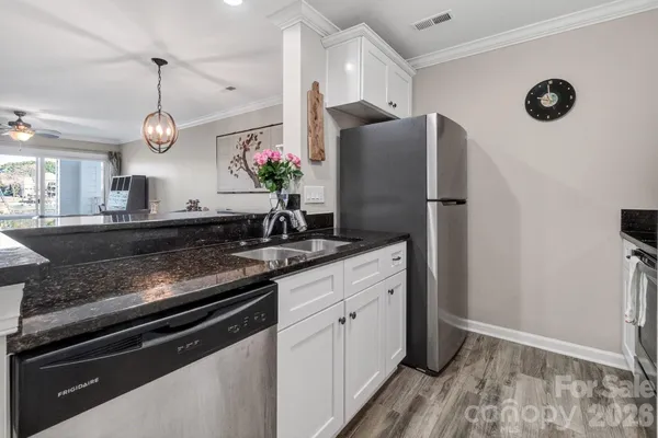 a kitchen with a refrigerator and a sink
