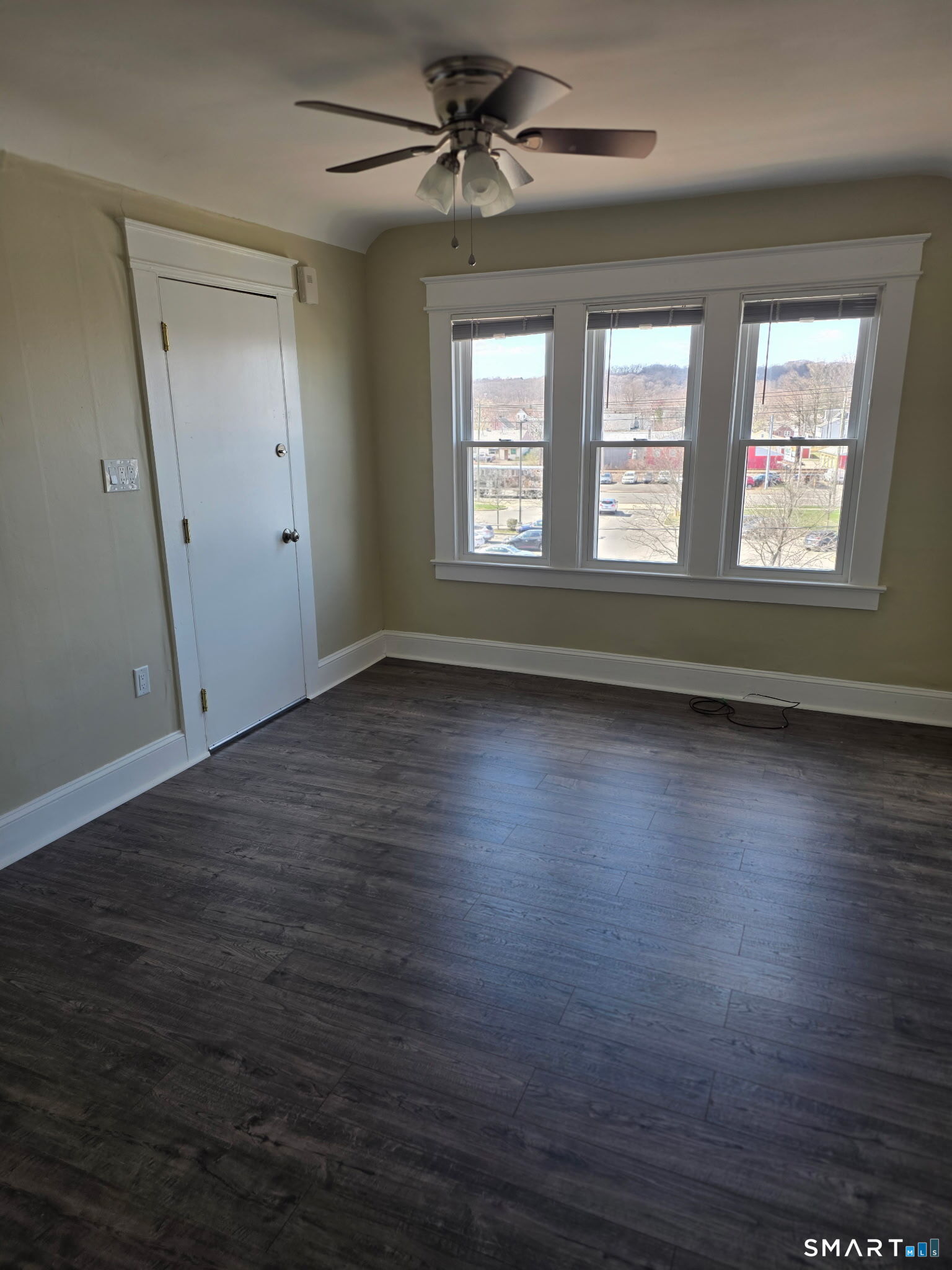22 Calvin Avenue Wallingford, CT 06492 - Photo 6 of 10 an empty room with wooden floor and windows