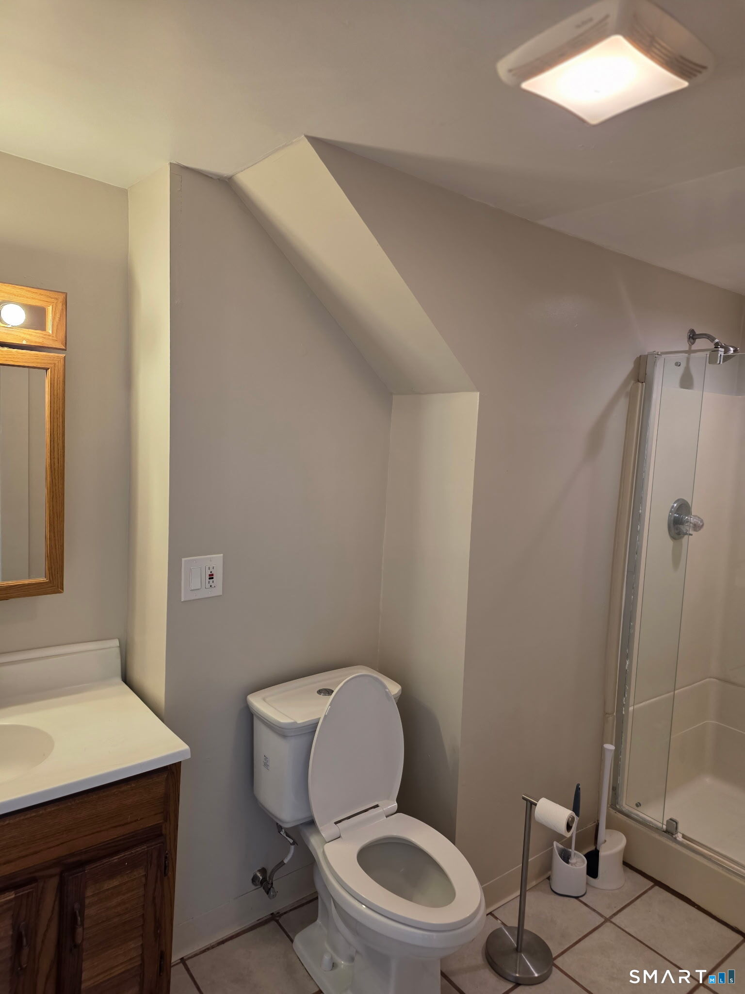 22 Calvin Avenue Wallingford, CT 06492 - Photo 8 of 10 a white toilet sitting next to a bathroom sink