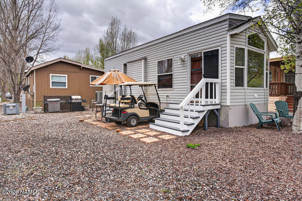a view of a house with a yard patio and fire pit