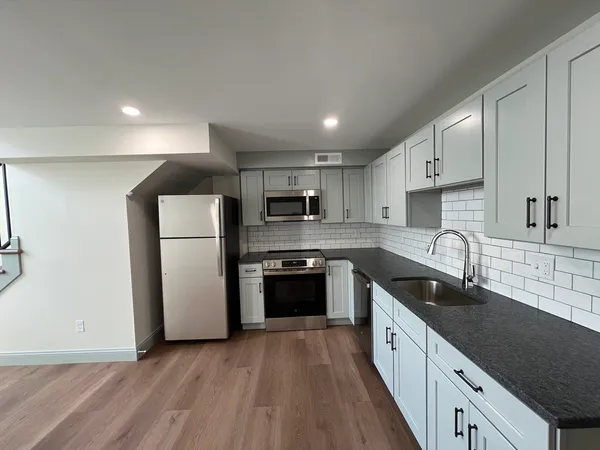a kitchen with refrigerator a sink and cabinets