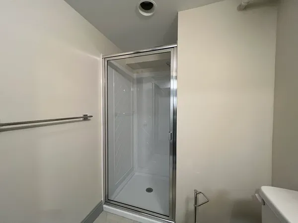 a bathroom with a glass shower door
