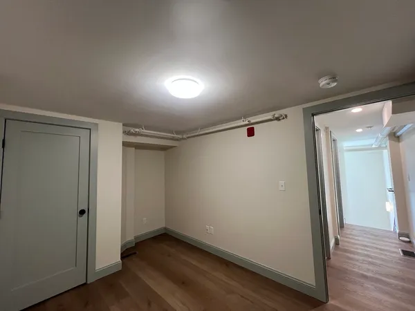 a view of hallway with wooden floor