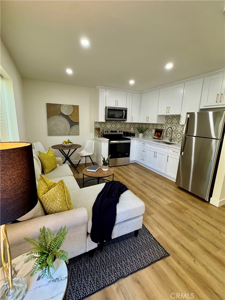 6210 Halstead Avenue Rancho Cucamonga, CA 91737 - Photo 6 of 9 a living room with furniture and a rug