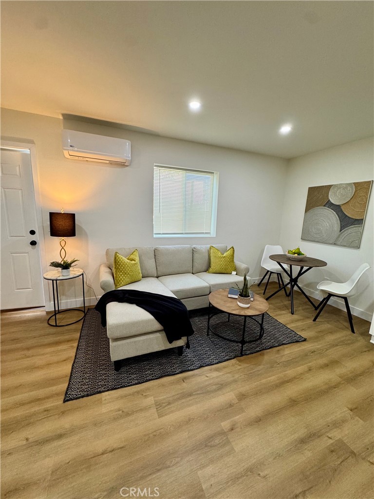 6210 Halstead Avenue Rancho Cucamonga, CA 91737 - Photo 8 of 9 a living room with furniture and wooden floor