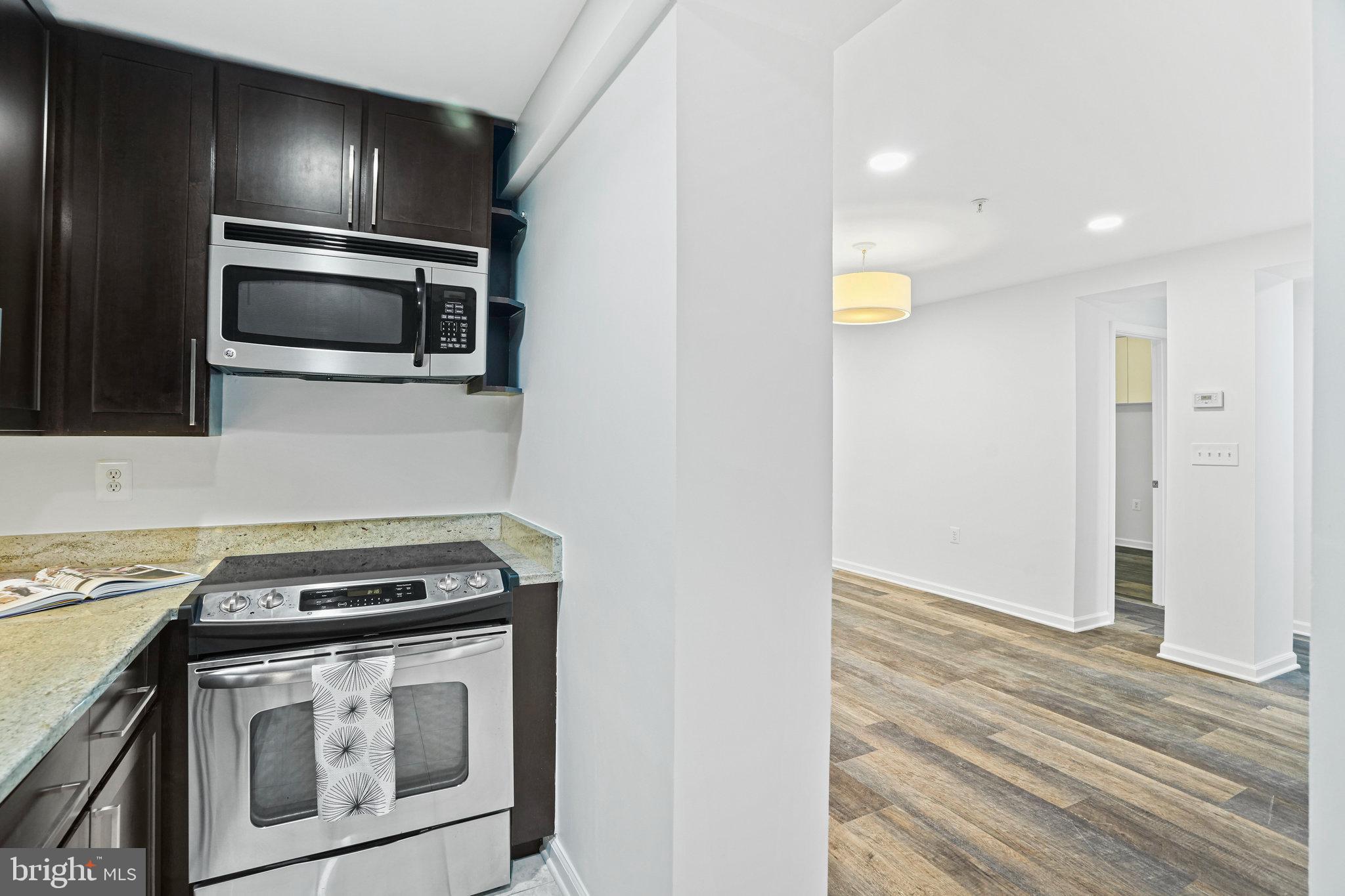 2627 Adams Mill Road Northwest, Unit T3 Washington, DC 20009 - Photo 12 of 19 a kitchen with a stove and a microwave