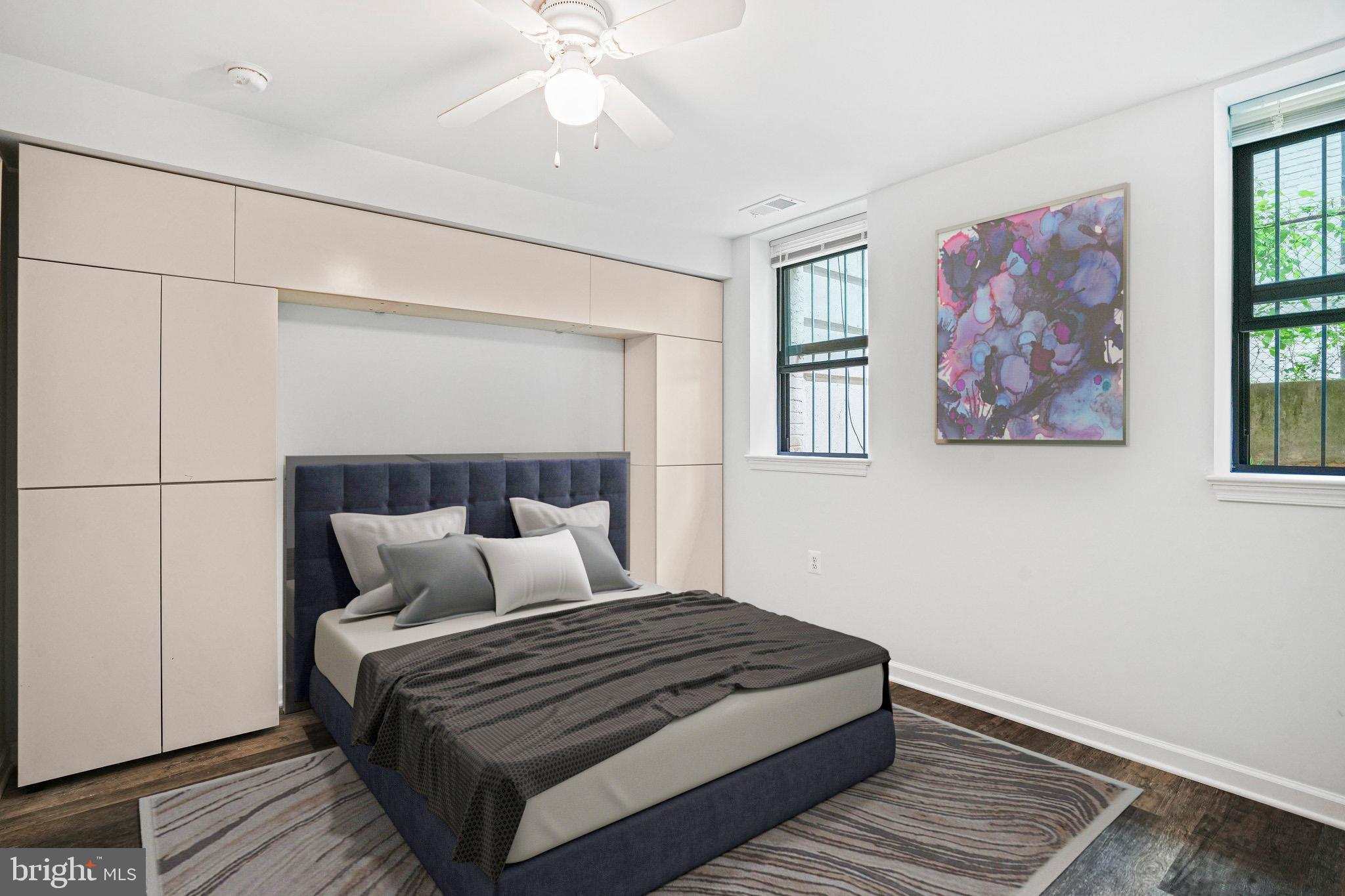 2627 Adams Mill Road Northwest, Unit T3 Washington, DC 20009 - Photo 14 of 19 a bedroom with a large bed and a chandelier