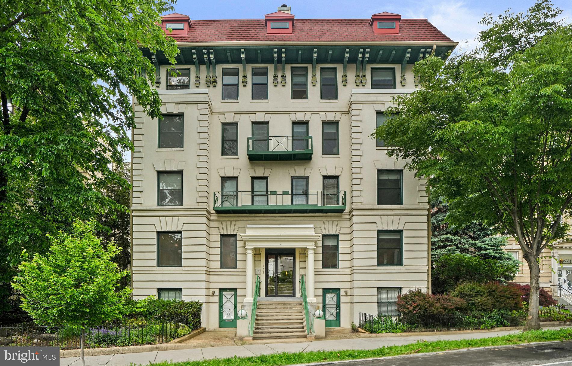 2627 Adams Mill Road Northwest, Unit T3 Washington, DC 20009 - Photo 2 of 19 a front view of a residential apartment building with a yard