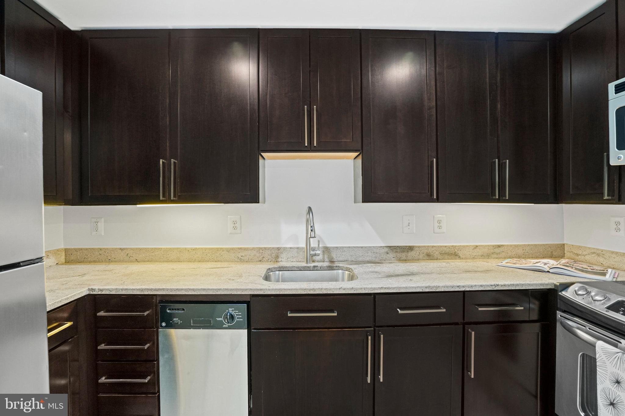 2627 Adams Mill Road Northwest, Unit T3 Washington, DC 20009 - Photo 10 of 19 a sink with granite countertop cabinets