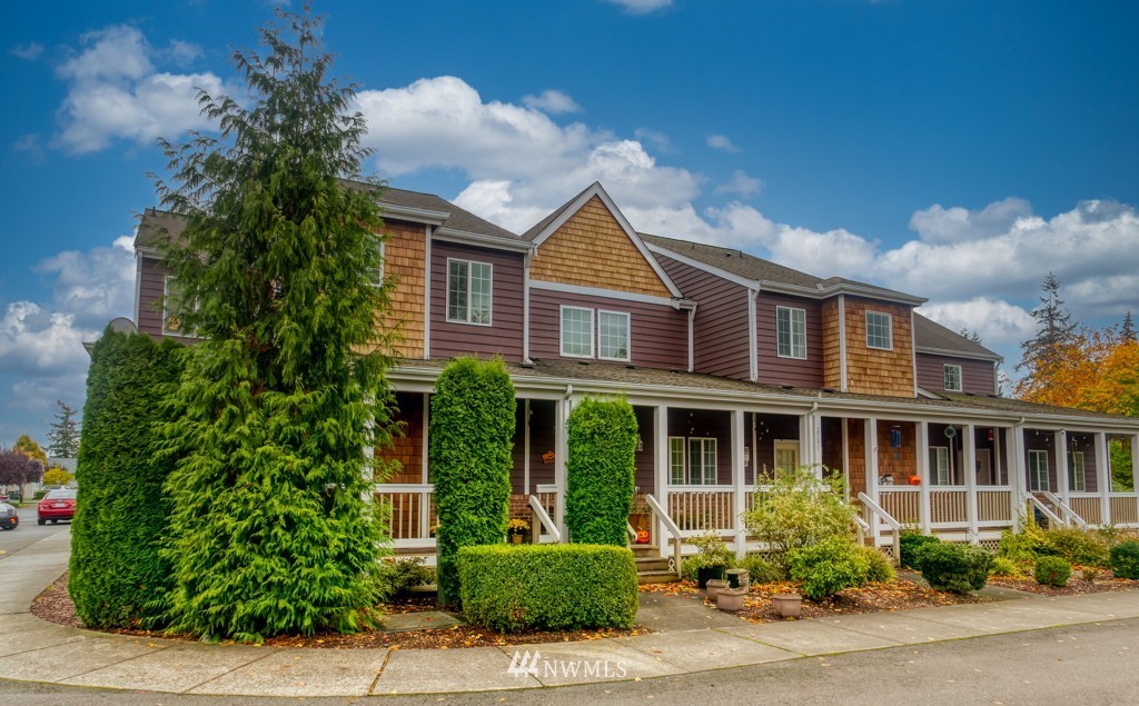 a front view of a house with a garden and plants