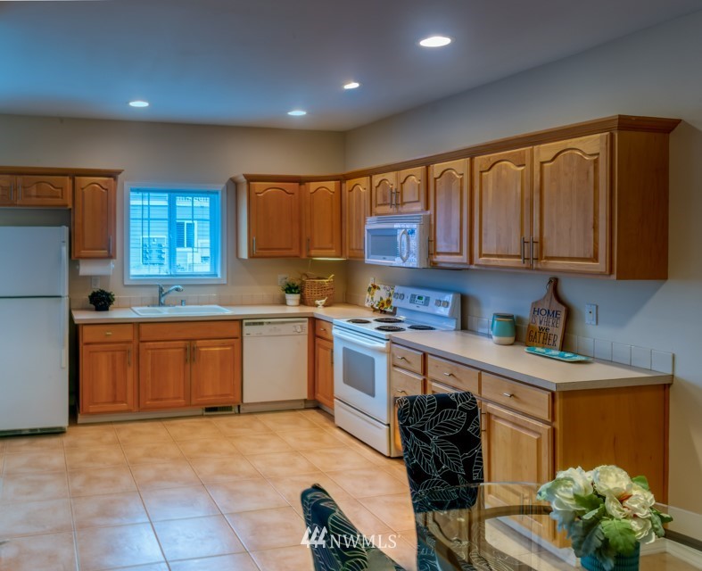 2731 Diamond Loop Milton, WA 98354 - Photo 13 of 28 a kitchen with stainless steel appliances granite countertop a stove sink and cabinets
