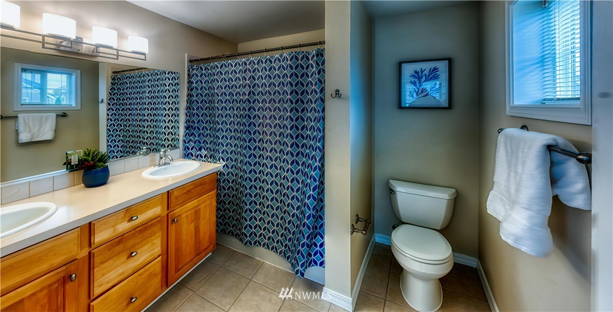 2731 Diamond Loop Milton, WA 98354 - Photo 18 of 28 a bathroom with a toilet sink and mirror