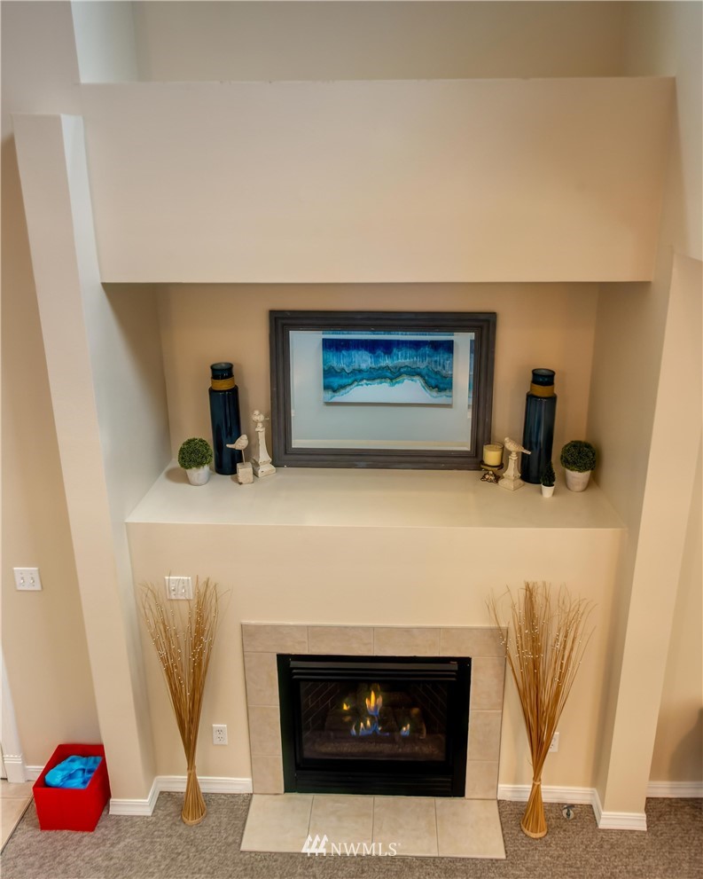 2731 Diamond Loop Milton, WA 98354 - Photo 6 of 28 a kitchen with a fireplace and cabinets