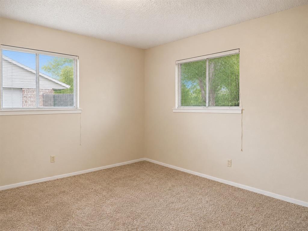 2111 Quail Run, Unit A McKinney, TX 75071 - Photo 7 of 12 an empty room with a window