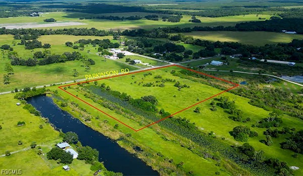 18030 Parkinson Road Alva, FL 33920 - Photo 3 of 8 a view of a lake with a yard