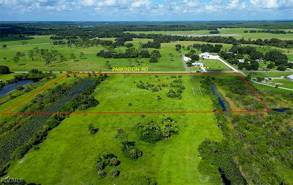 18030 Parkinson Road Alva, FL 33920 - Photo 5 of 8 a view of a green field with an outdoor space