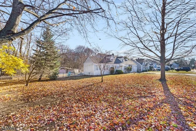 a view of yard covered with snow in front of house