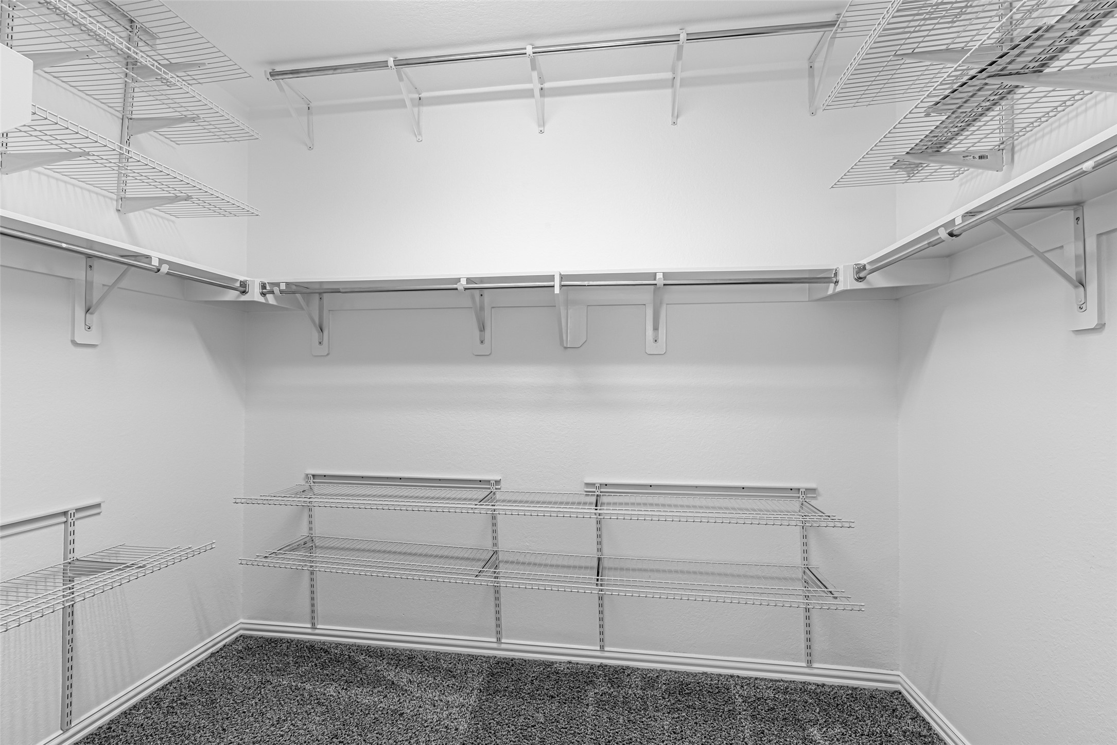 23635 Kingston Ridge Way Katy, TX 77493 - Photo 19 of 36 Walk-in closet featuring multiple shelves and hanging racks, providing ample storage and organization options.