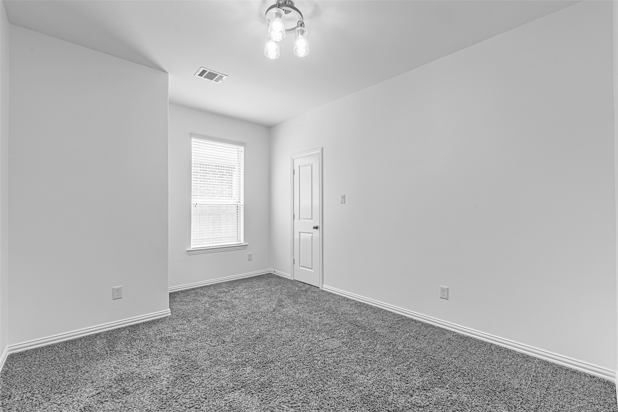 23635 Kingston Ridge Way Katy, TX 77493 - Photo 21 of 36 2nd bedroom downstairs featuring a window for natural light, a walk-in closet, and a modern light fixture