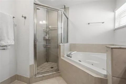 a bathroom with a bathtub and a shower