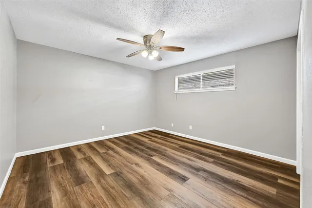 a view of room with window and ceiling fan