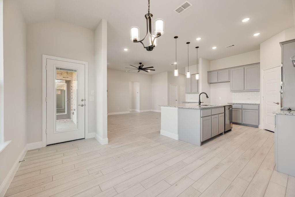 597 MB's Way Pilot Point, TX 76258 - Photo 21 of 34 a large white kitchen with a large island oven a sink stainless steel appliances and cabinets