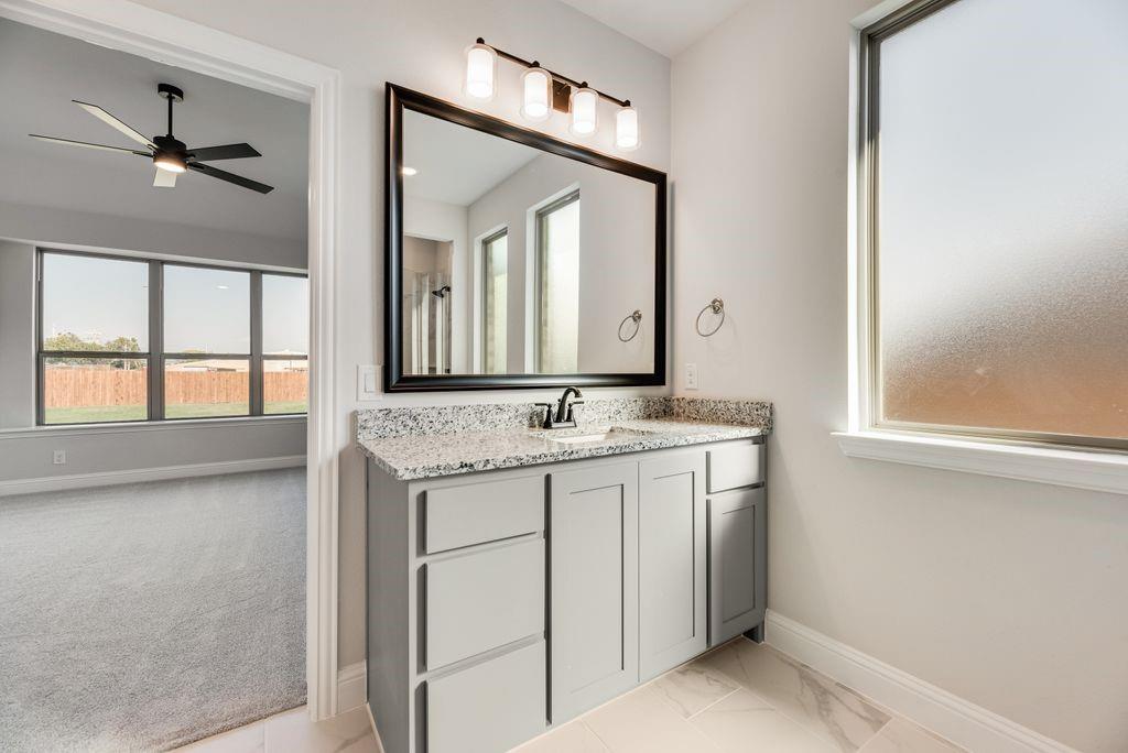 597 MB's Way Pilot Point, TX 76258 - Photo 26 of 34 a bathroom with a granite countertop sink and a mirror